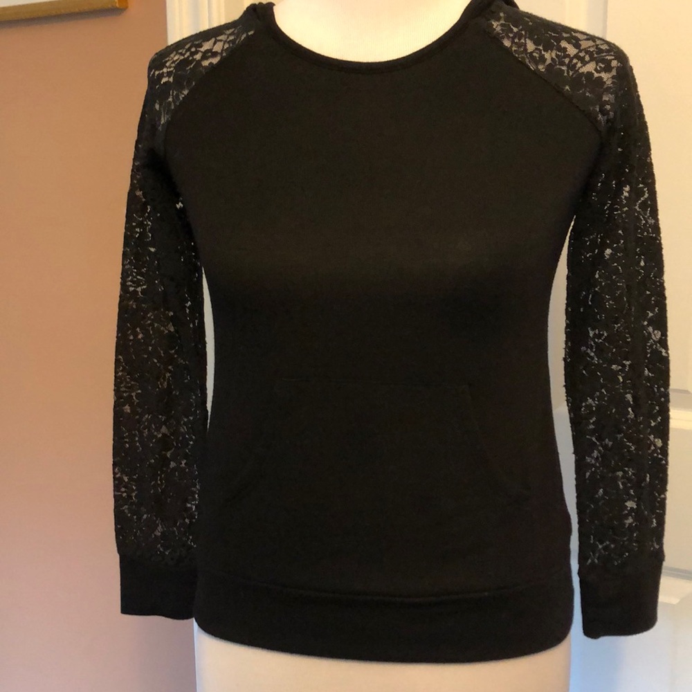 Black hooded top with lace sleeves.